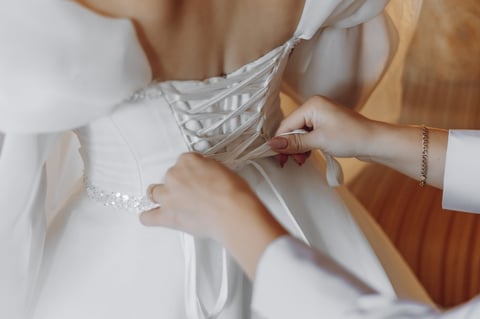 Bride adjusting wedding dress